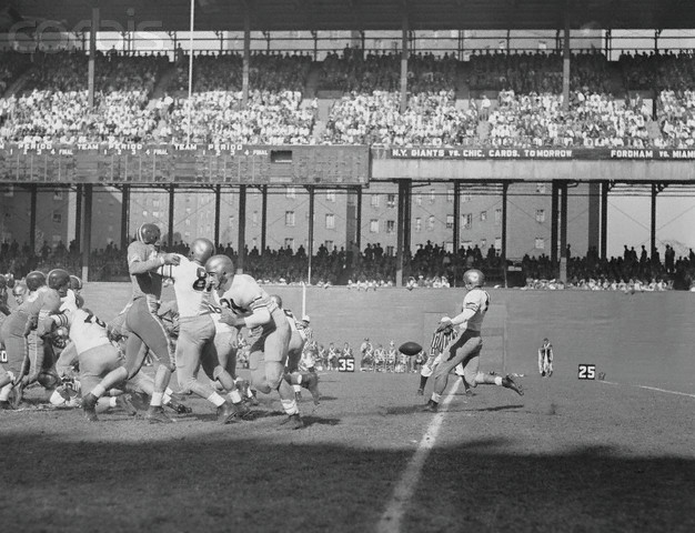 17 Oct 1953, Manhattan, New York, New York, USA --- Army football team player, Chesnauskas (63), quick kicks the ball in first quarter of Army v. Duke University game at Manhattan's Polo Grounds. --- Image by © Bettmann/CORBIS